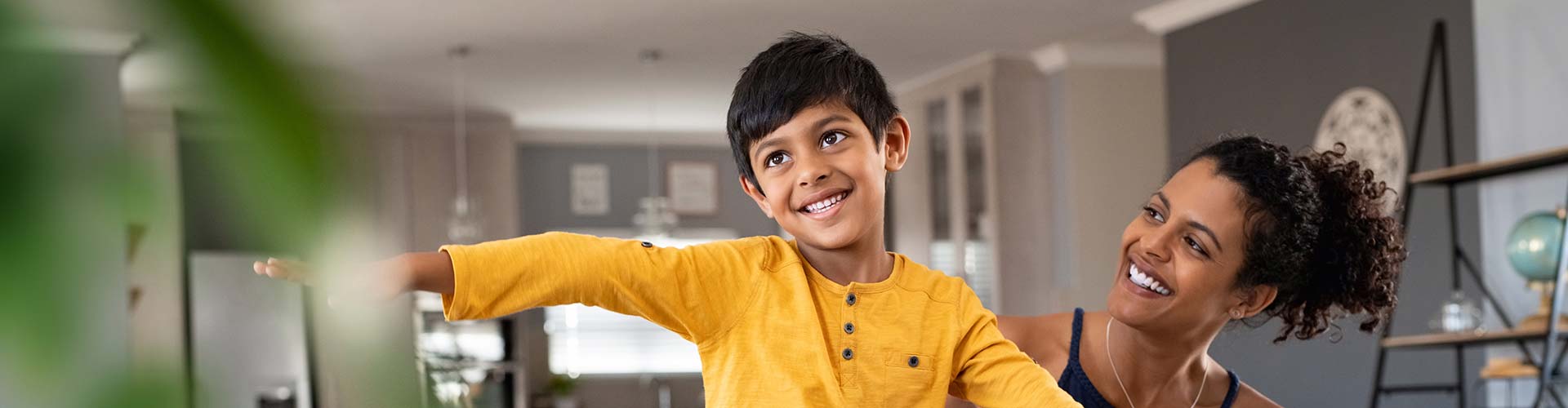 A child wearing a yellow shirt in a comfortably cooled room