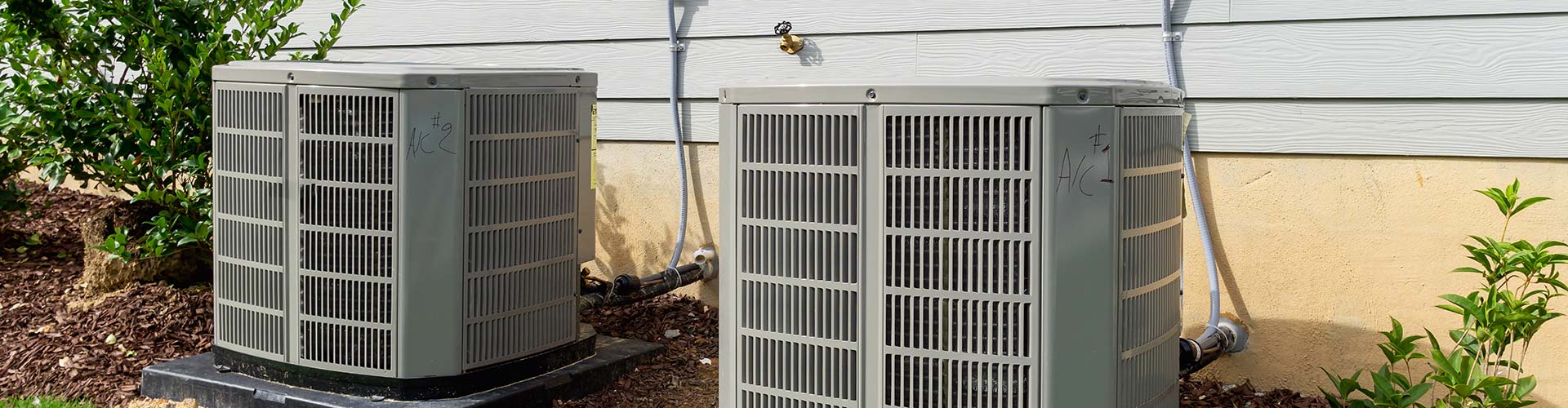 A white metal vent on a wall in a home with air conditioning