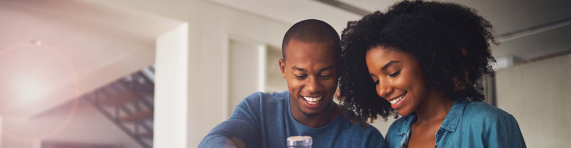 A person smiling at their cell phone while scheduling HVAC maintenance